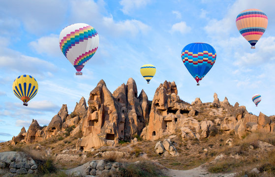 Colorful hot air balloons flying over the valley in Cappadocia, Anatolia, Turkey