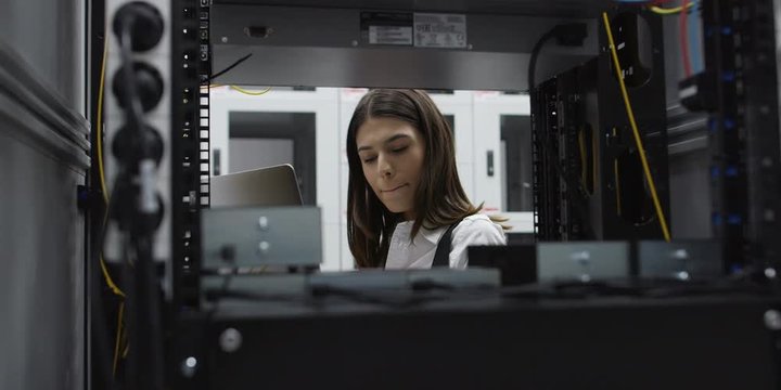woman using computer in server room