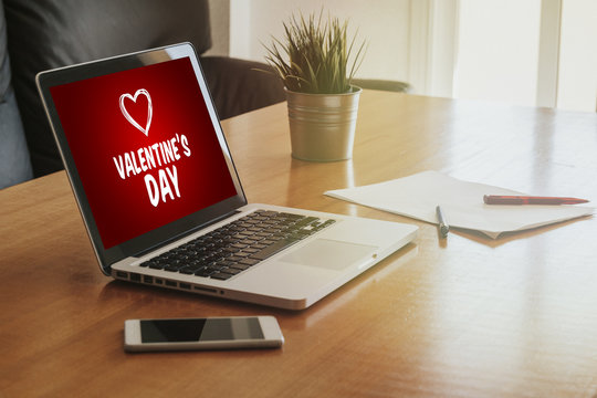 Laptop with a Valentine's day shopping website in the screen at the office.