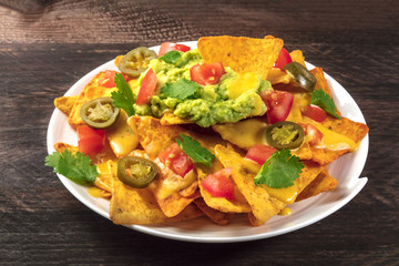 Nachos with cheese and hot peppers, traditional Mexican snack