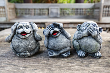 Three monkey,close up of hand small statues with the concept of see no evil, 
hear no evil and speak no evil.