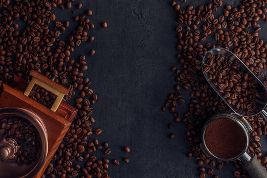 top view of roasted coffee beans, coffee grinder and scoop on black © LIGHTFIELD STUDIOS
