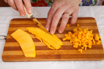 Food preparation - chopping of pumpkin with knife