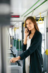 Smiling Woman Talking On Phone in Bus.