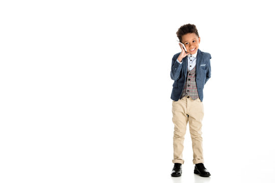 smiling african american kid talking by smartphone on white