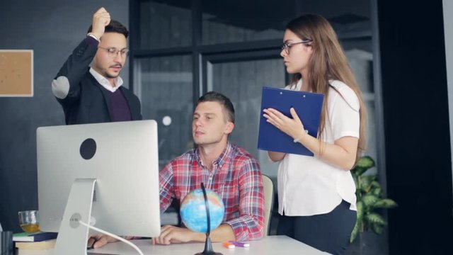 Coworkers in a modern office working on project in company