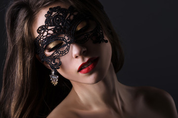 Attractive woman in lace mask. Portrait