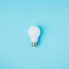 close up view of white light bulb isolated on blue