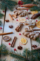 Powdered spices for mulled wine Christmas bakery orange, anise, cinnamon, ginger, viburnum on wooden background. Decorated with Christmas tree branches, pine cones. New year composition. Horizontal