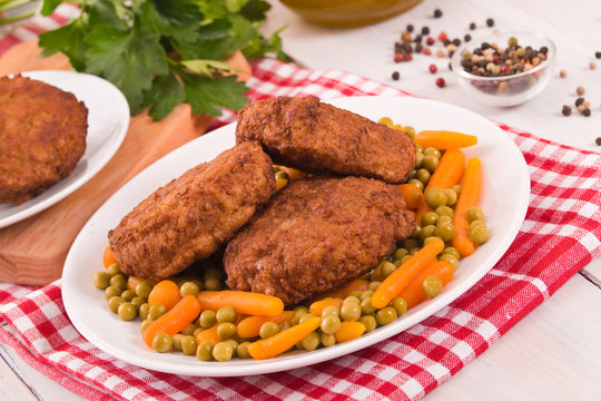 Meatballs on white dish.