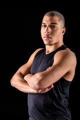 Fototapeta premium African american man standing with crossed arms isolated on black