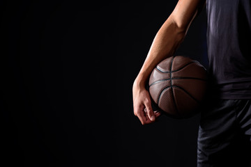 cropped shot of basketball player with ball isolated on black