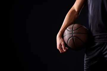  cropped shot of basketball player with ball isolated on black © LIGHTFIELD STUDIOS