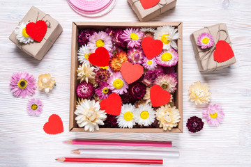 Preparing Valentine day gift, flowers box on wooden background