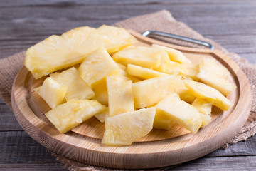 Piece of pineapple on a cutting board on the table