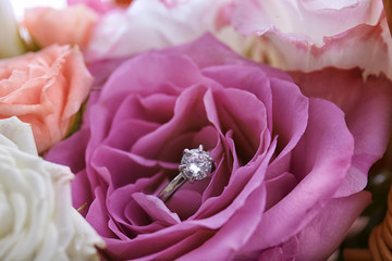 Close up view of engagement ring with flowers