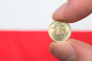 Polish coin on polish flag background