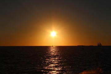 Naklejka na ściany i meble Sunset at sea beautiful light and black sea 