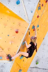 Foto op Aluminium  little girl climbing up the wall © Sergii Mostovyi