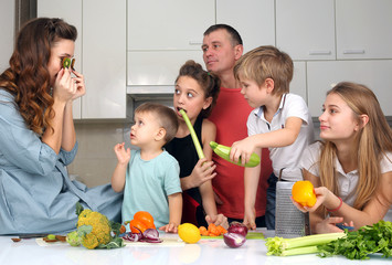 family with children having fun over cooking