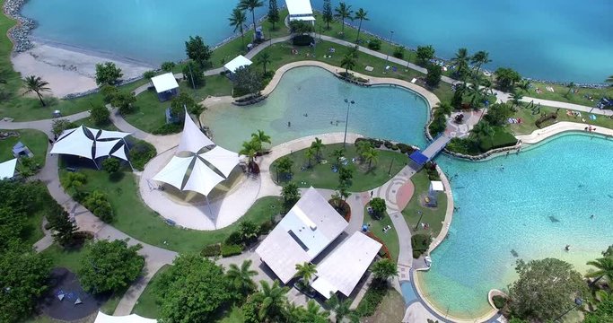 WHITSUNDAY ISLANDS – FEBRUARY 2016 : Aerial shot over swimming pool on a sunny day with Airlie Beach cityscape in view