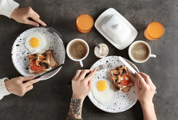 Women having breakfast with toasts at table, top view