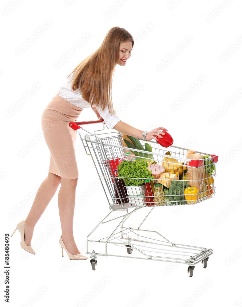 Poster young woman with full shopping cart on white background