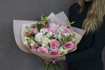 The delicate rustic floral bouquet in woman hands