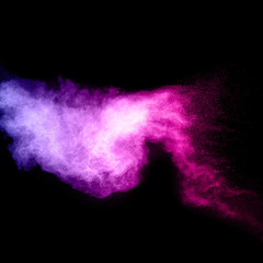 abstract pink powder explosion on  black background. abstract pink dust  splattered on dark ...