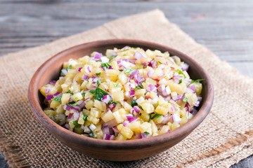 Pineapple salsa in a ceramic bowl on a wooden table