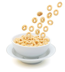 Cereal rings falling on a bowl on a white background