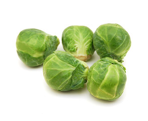 Obraz premium Freshly brussel sprouts and some whole ones on a white background