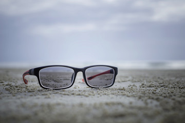 Sunglasses on the sand at the beach.