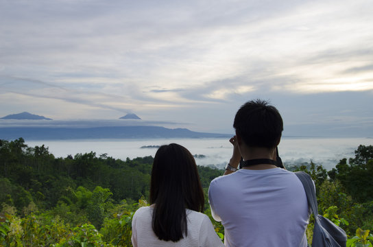 couple enjoying puthuk setumbu nirwana sunrise borobudur, yogyakarta, indonesia