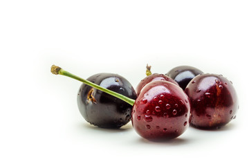 Wet ripe fresh cherries isolated on white background.