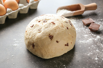 Raw dough with chocolate chips on table