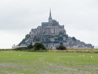 Fototapeta na wymiar Mont St. Michel, Normandy, France. Le Mont Saint-Michel is an island located about one kilometre off the country's northwestern coast. 