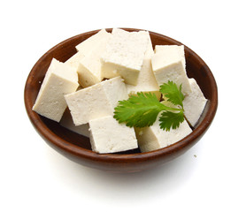 Closeup tofu isolated in wooden bowl on white background