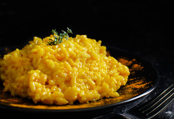 Risotto with curcuma on a dark background