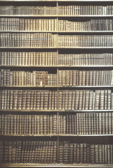 Retro toned old books on wooden shelves, education concept background.