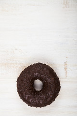 Donut close-up on a wooden background.