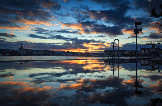 Winter sunset reflected in a pubble on pier Bains des Paquis in Geneva. Switzerland.
