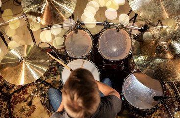 musician or drummer playing drum kit at studio