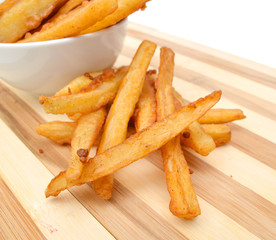 Homemade oil fried sweet potato fries on wooden board on white background
