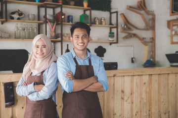 two cafe owner standing with crossed arms