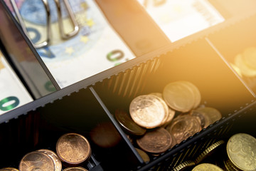 Cash register with coins and paper money