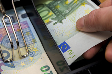 Cash register with coins and paper money