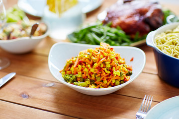 vegetable salad with corn and other food on table