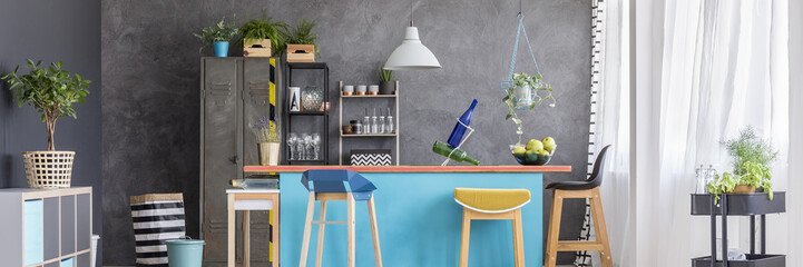 Yellow stool in blue kitchen