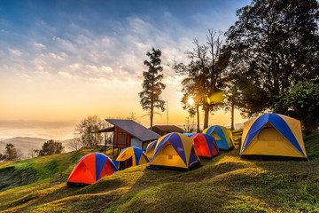 Camping tents on the top of mountain during sunrise at San pa kia to see Doi Luang Chiangdao,...